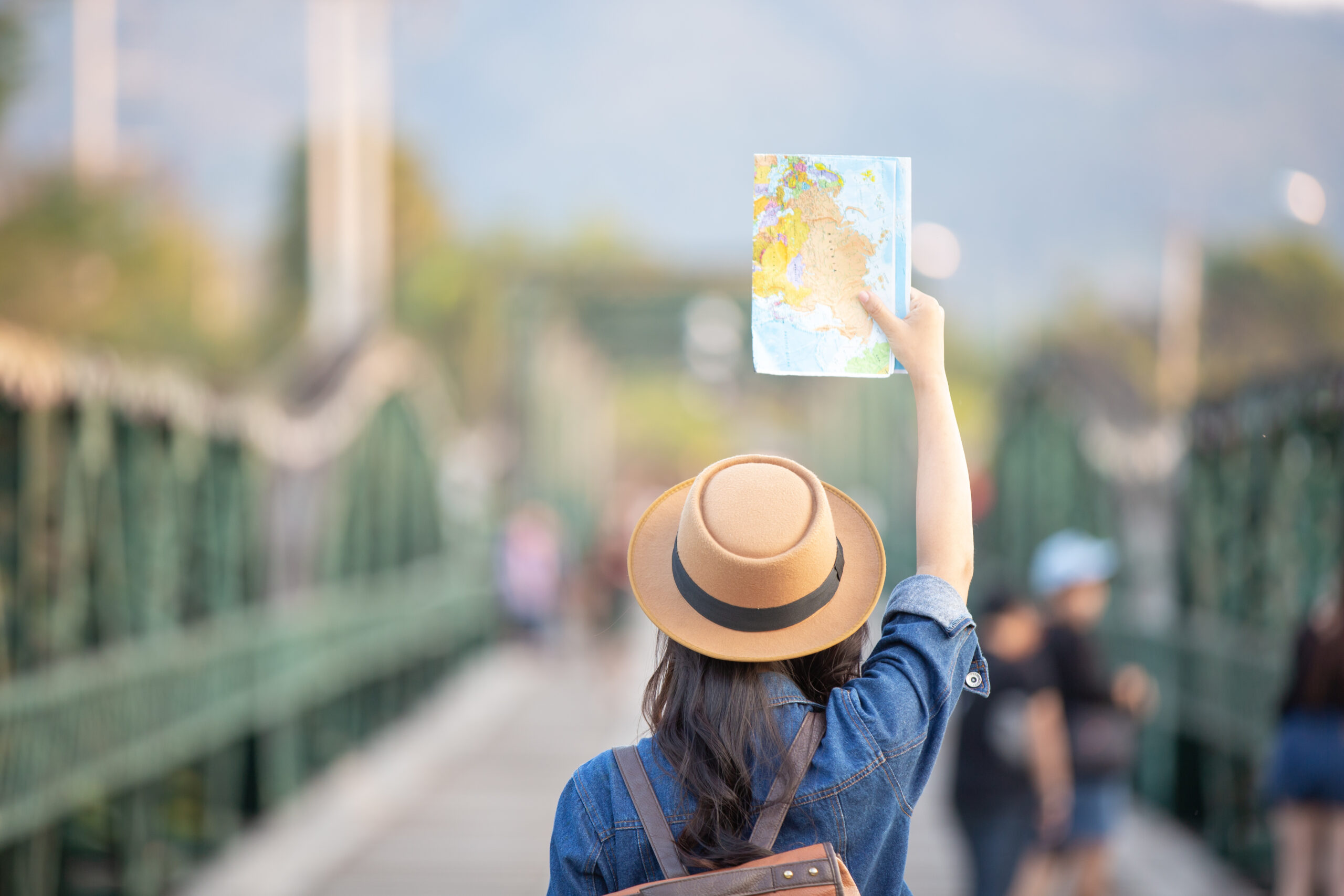 Female tourists on hand have a happy travel map